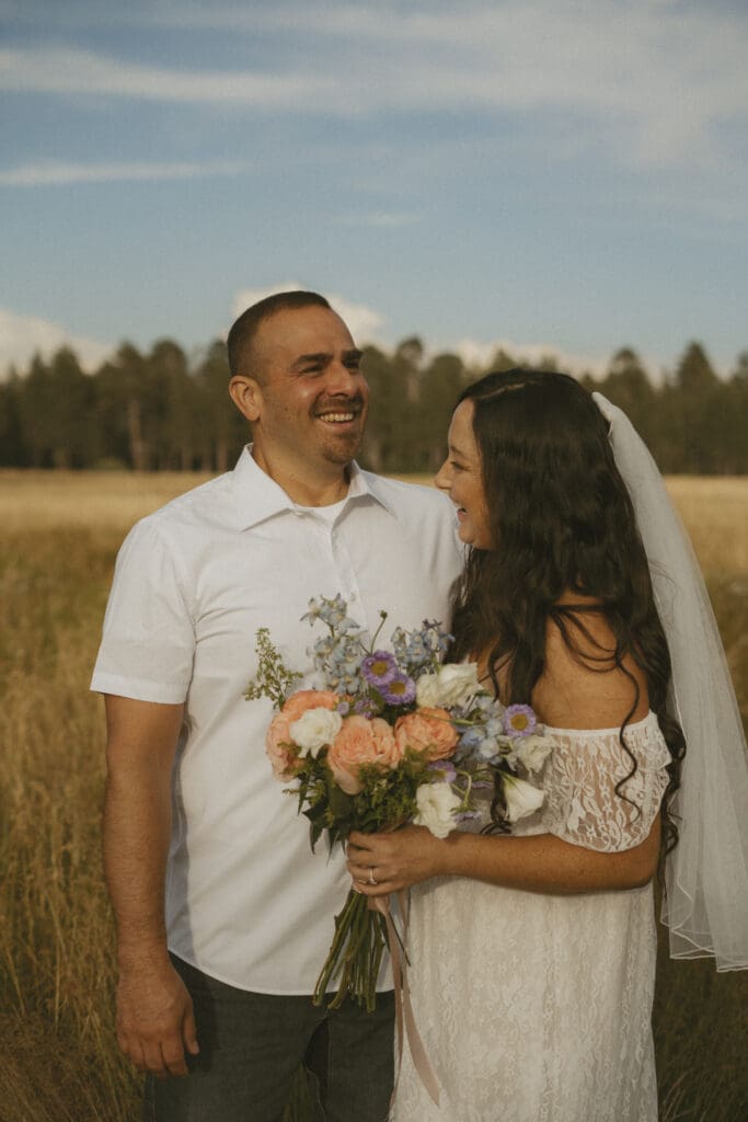 Couple eloping. Beautiful flower bouquet. 