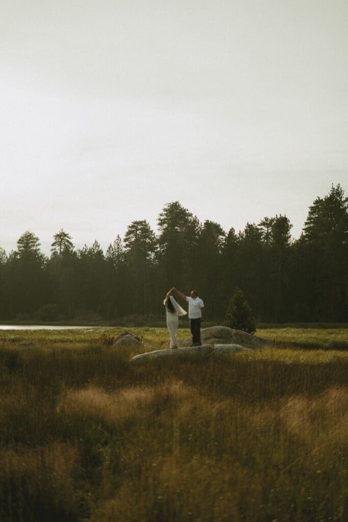 Taking wedding photos on the rocks in the middle of the meadow

